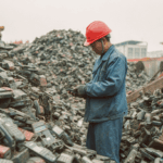 rosalandy_A_worker_in_a_blue_work_uniform_and_a_red_helmet_is_s_1c8bcb9e-7c68-4c91-82ba-03a5070e56a6.png